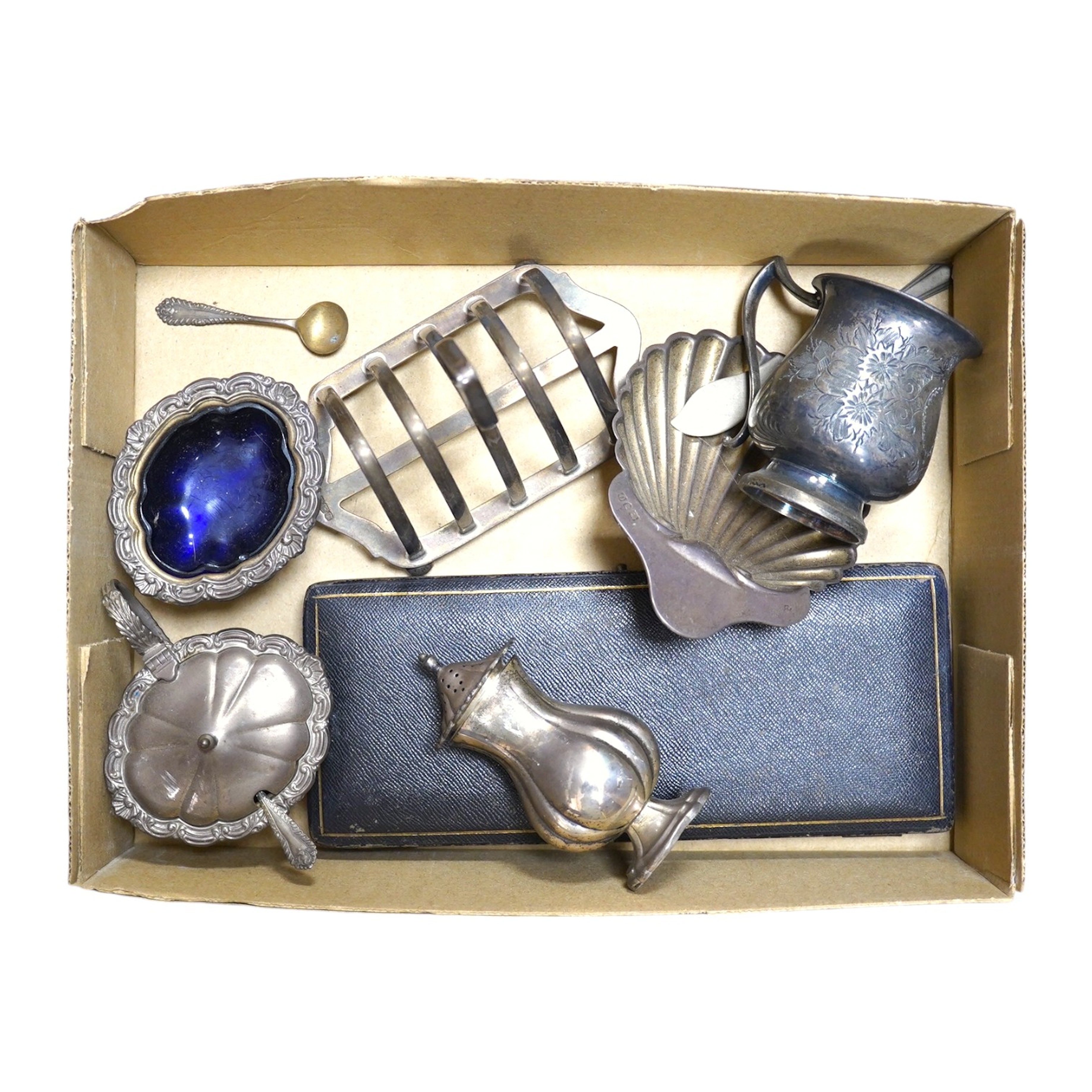 A group of assorted silver and plated wares including a silver scallop butter dish and knife and a three piece condiment set, 12 oz of weighable silver. Condition - oxidised otherwise good